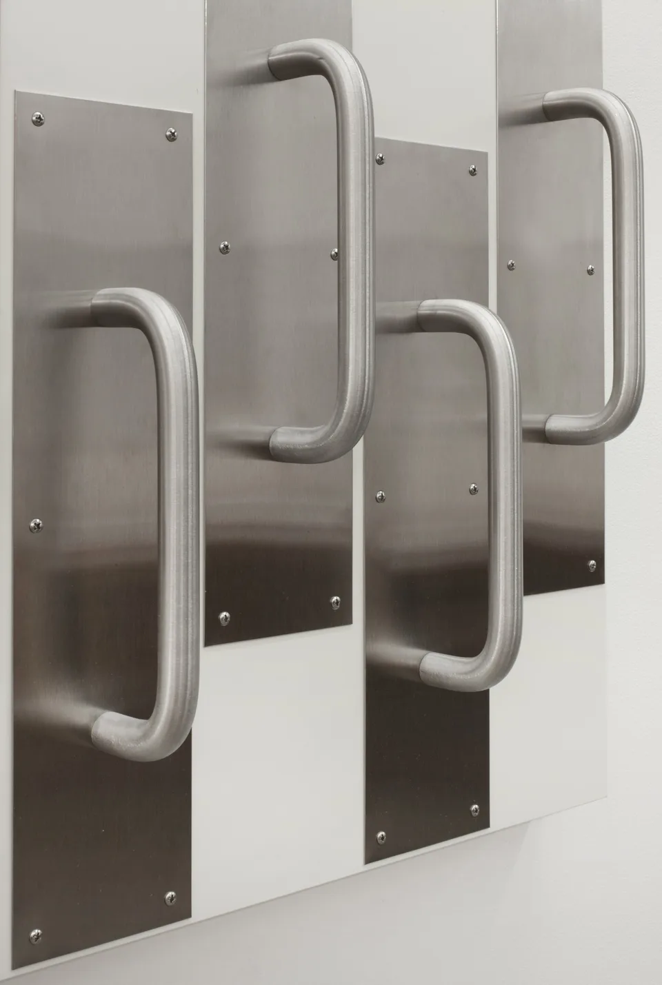 Close view of the metal door handles arrangement