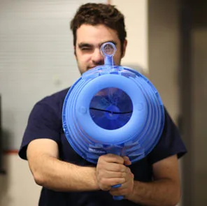 A participant holding the blue scent-projecting device used in Gentle Trauma