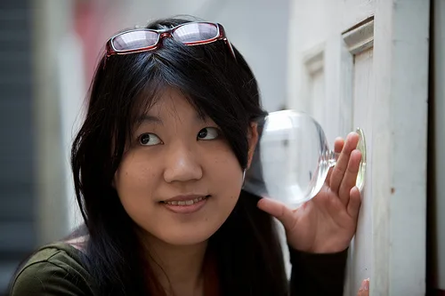 A participant holds a glass against the anyDoor listening installation