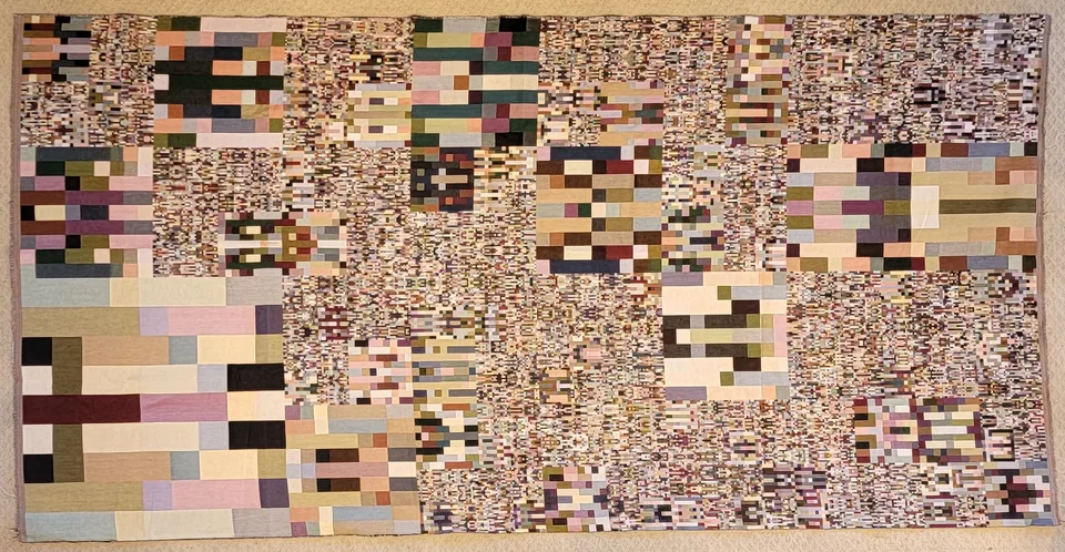 Small rectangles and repeated patterns form a long pale geometric tapestry.