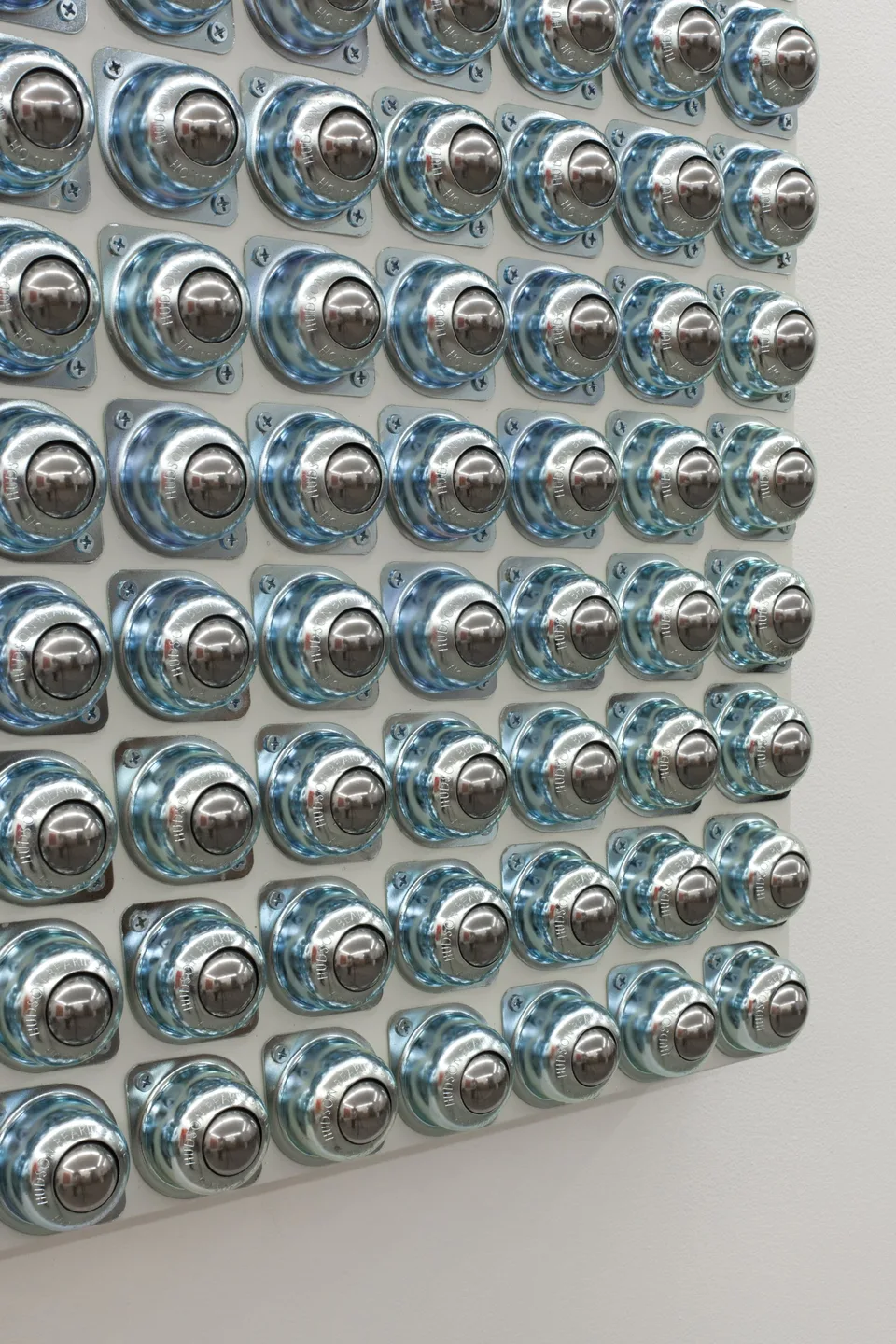 Oblique detail of a grid of circular metal fittings