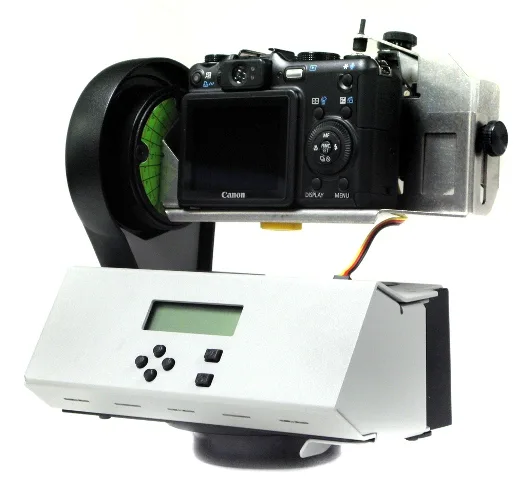 A camera and GigaPan mount isolated against a white background