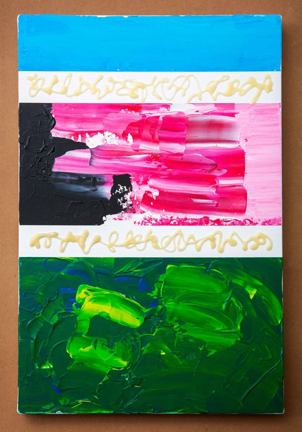 A vertical canvas has blue, pink-and-black and green painted sections separated by white bands with looping pale glue lines.