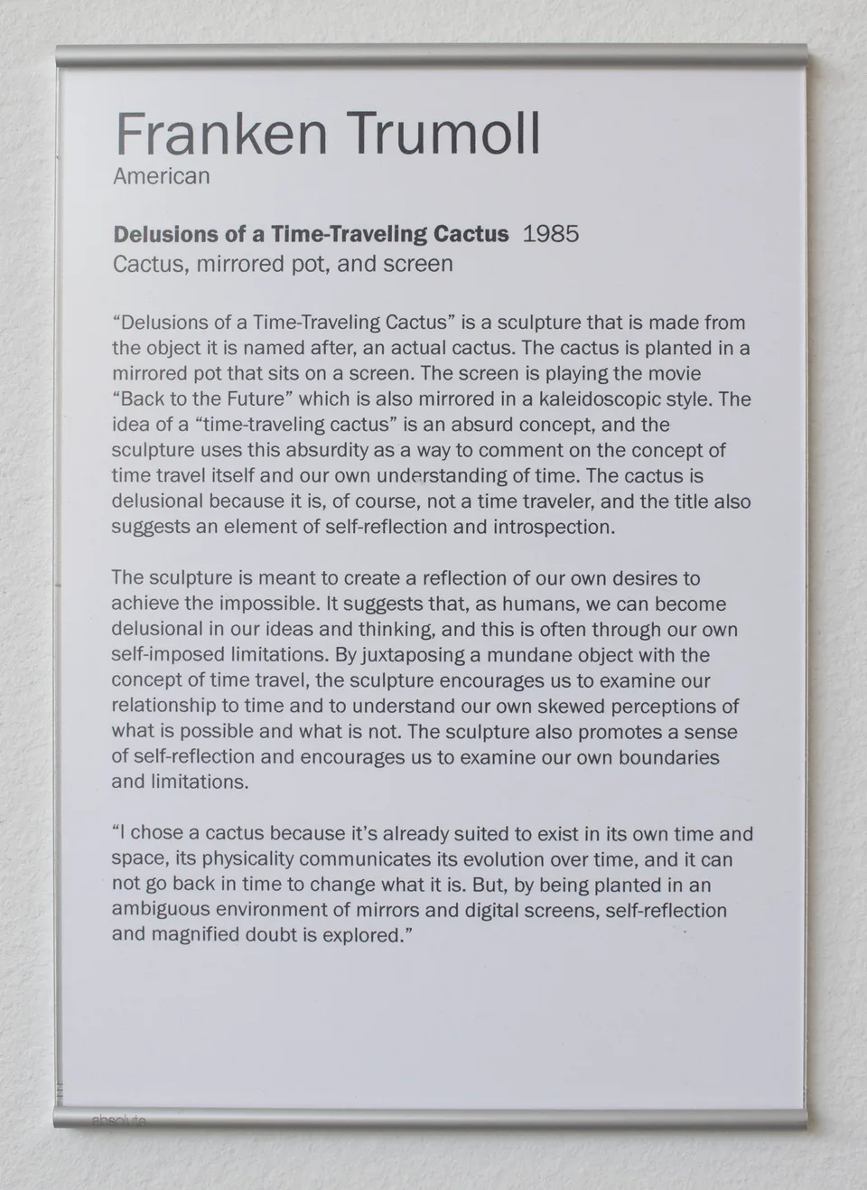 The printed label for Delusions of a Time-Traveling Cactus attributes the work to Franken Trumoll and dates it 1985.