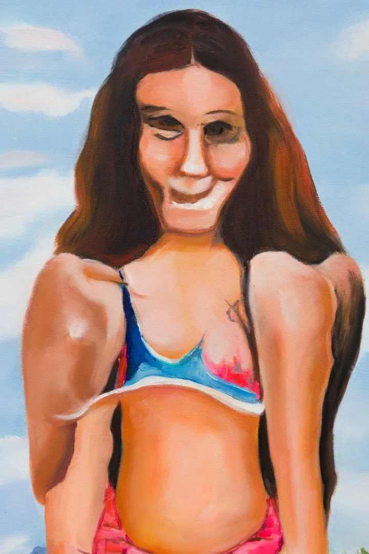 Detail of a painted long-haired figure in a colorful swimsuit against blue sky.