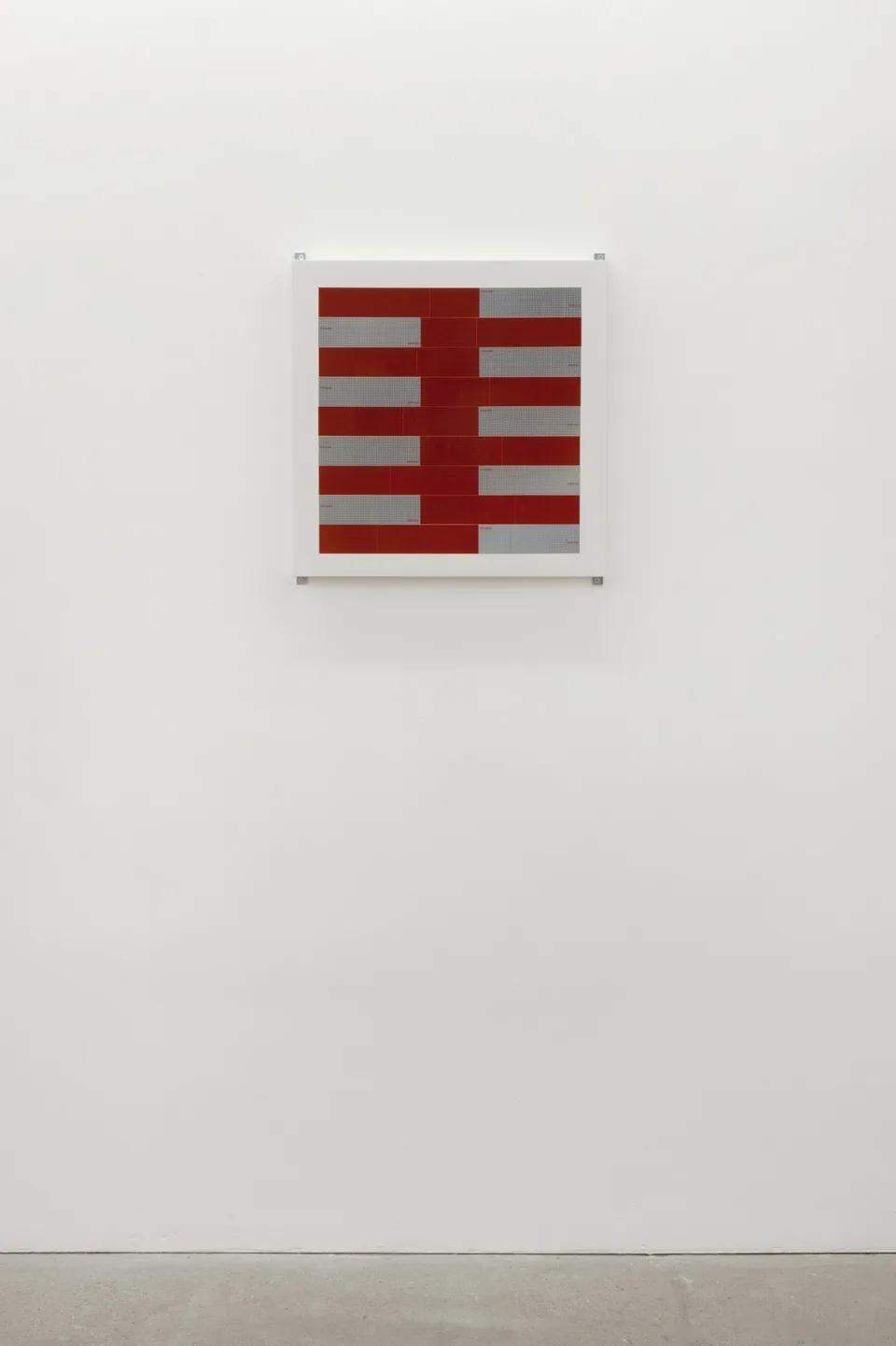 A wall-mounted composition of red and silver rectangular strips