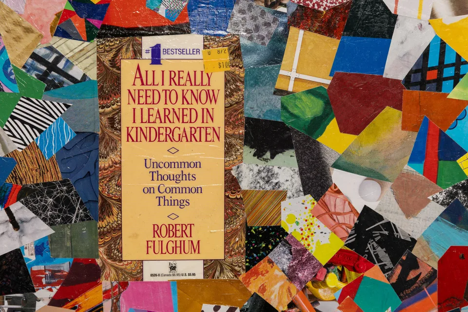 A close detail of the paperback cover and colorful paper fragments at the center of the collage.