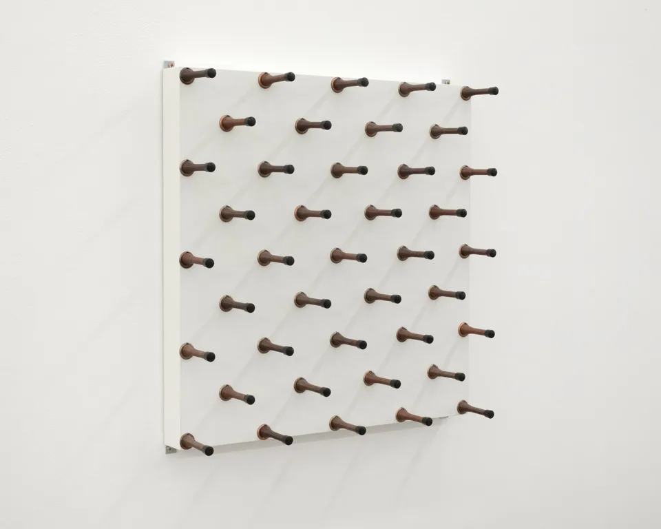 Angled view of spring door stops projecting from a panel