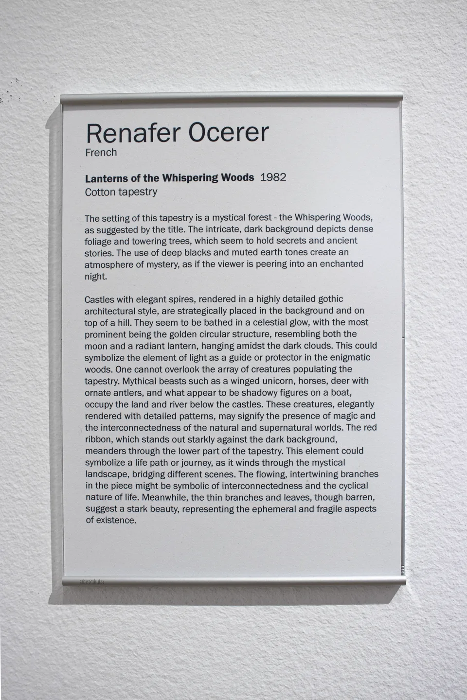 The printed label for Lanterns of the Whispering Woods attributes the tapestry to Renafer Ocerer and dates it 1982.