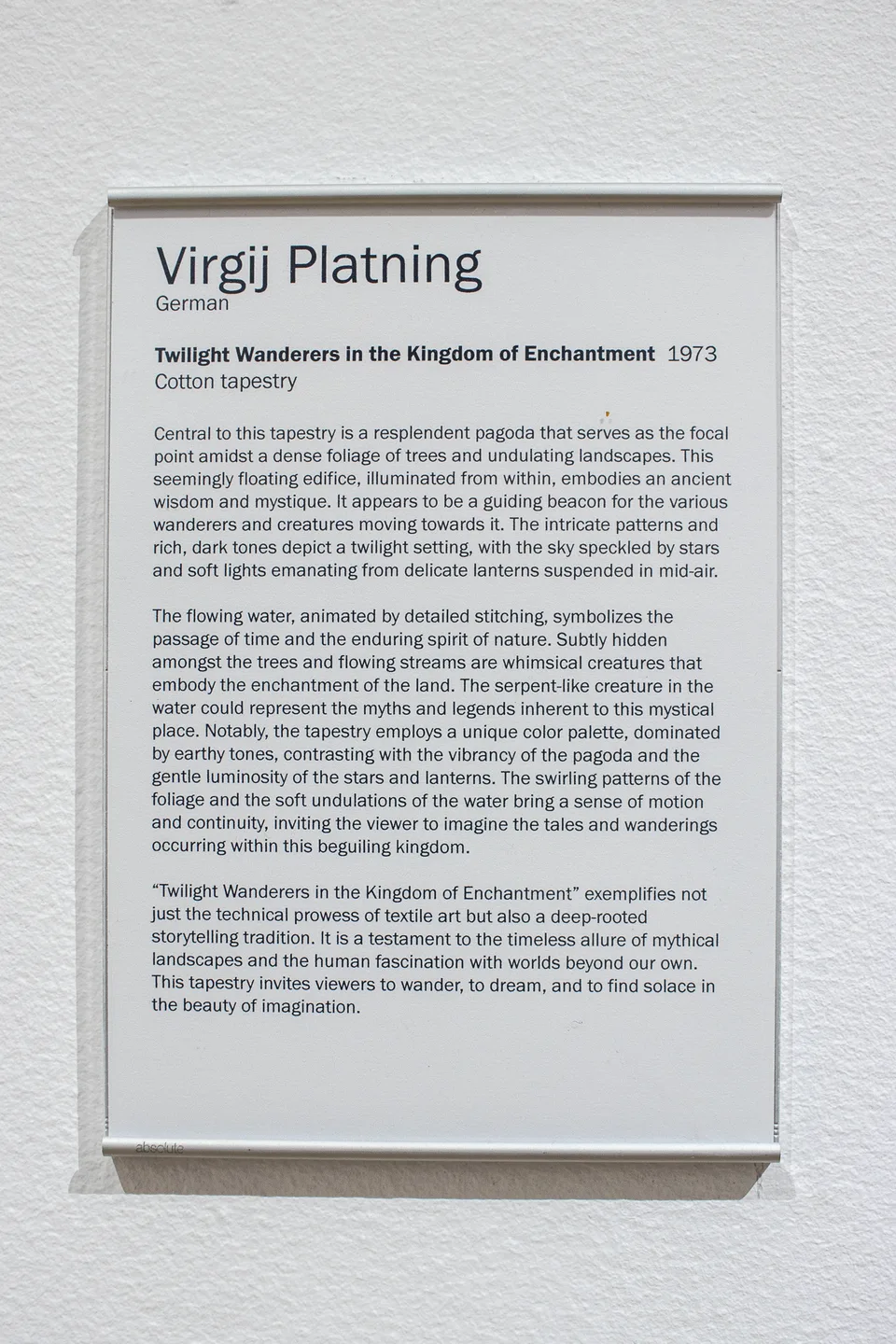 The printed label for Twilight Wanderers in the Kingdom of Enchantment attributes the tapestry to Virgj Platning and dates it 1973.