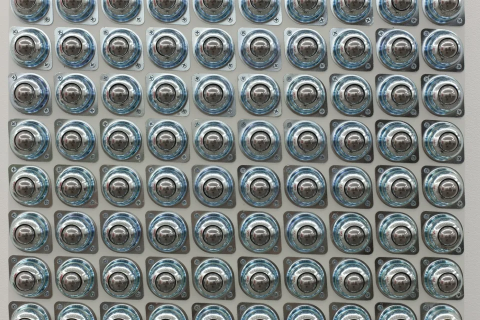 Close view of rows of circular metal fittings