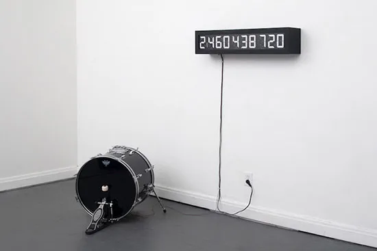 A black kick drum below a wall-mounted display counting the heartbeats remaining in Pulse Machine