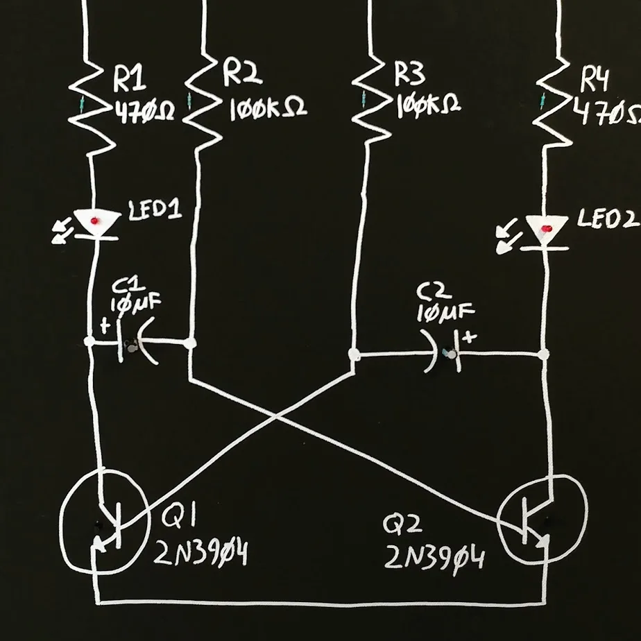 White electronic circuit symbols painted on black in concrete schematic